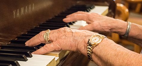Elderly woman plays piano