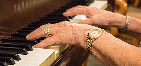 Elderly woman plays piano