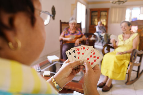 Elderly women play cards