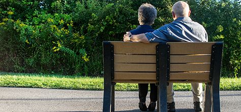 Elderly couple sitting on a park bench